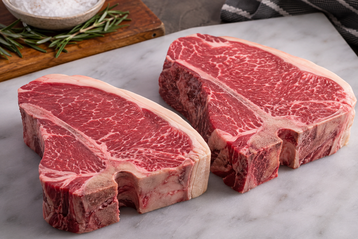 Raw Australian porterhouse steaks showing the fat edge before cooking