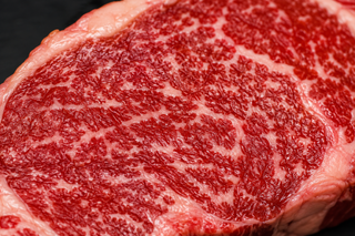 Close-up of raw beef showing fine intramuscular fat used in MSA and marble score grading