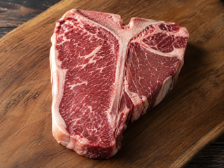 Raw T-bone steak showing the striploin and eye fillet either side of the T-shaped bone