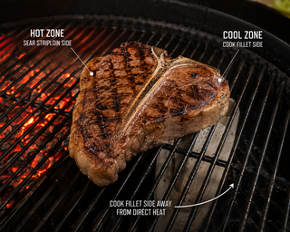 T-bone steak on a barbecue with the fillet side angled away from the hottest heat